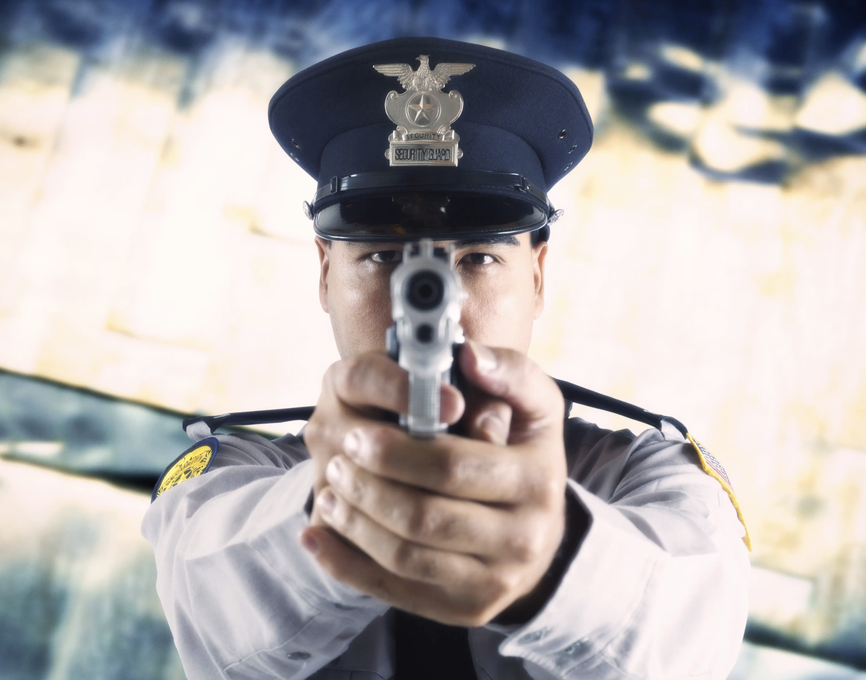 A policeman pointing a gun directly at the lens
